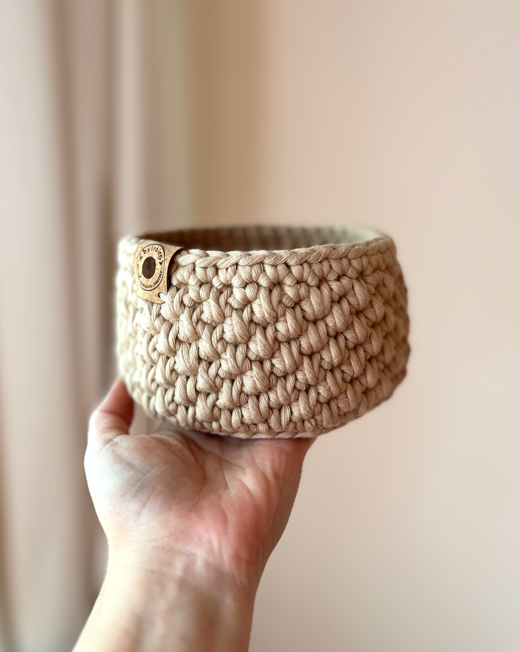 crochet storage basket, recycled cotton cord, eco friendly storage solution, sustainable homeware, handmade basket, eco friendly living, small crochet basket held up in one hand