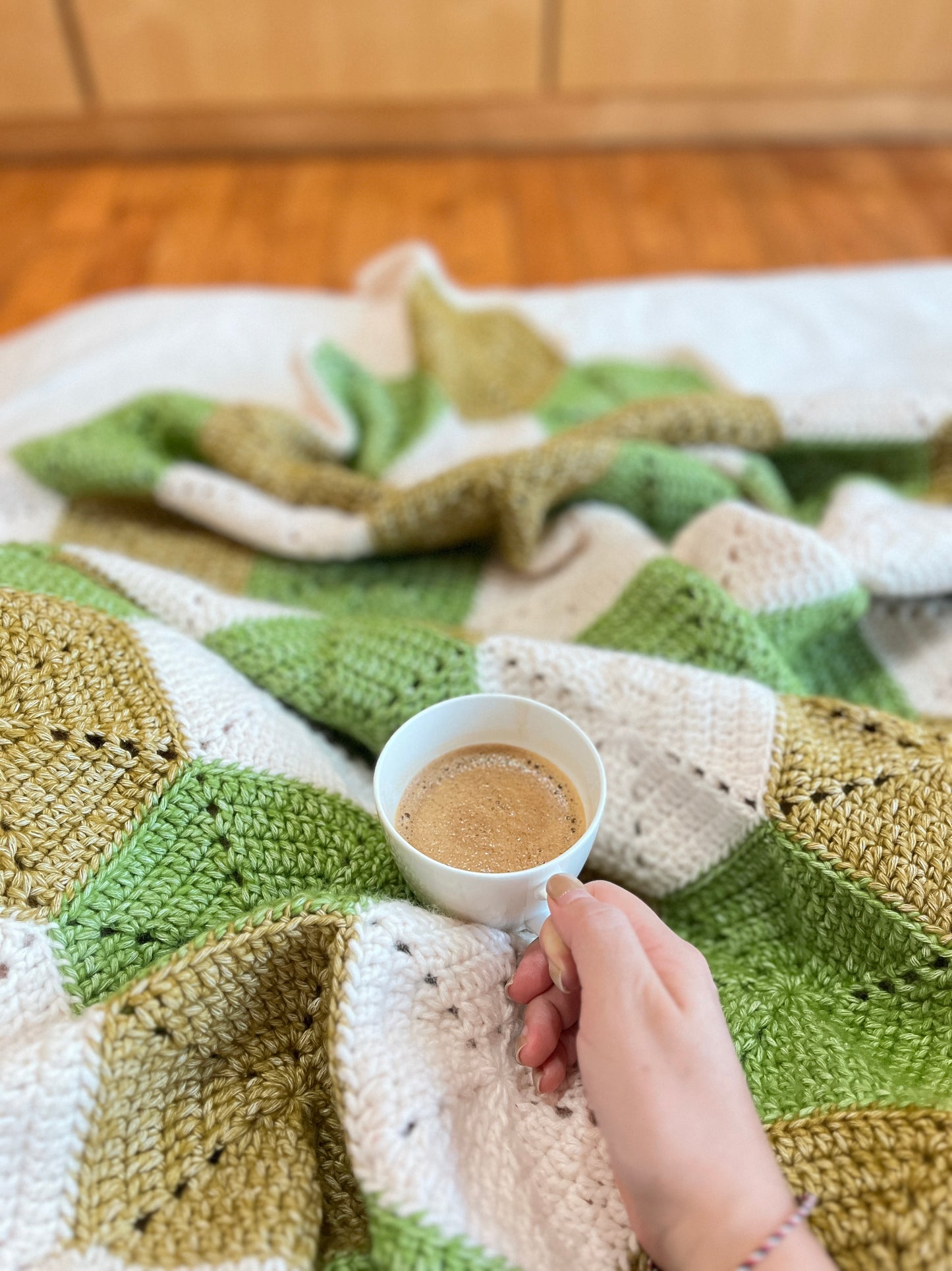 snuggling up in a crochet blanket, throw blanket, hexagon motifs, olive green, jasper yellow, handmade, cotton-blend, wool-sensitive, custom throw blanket