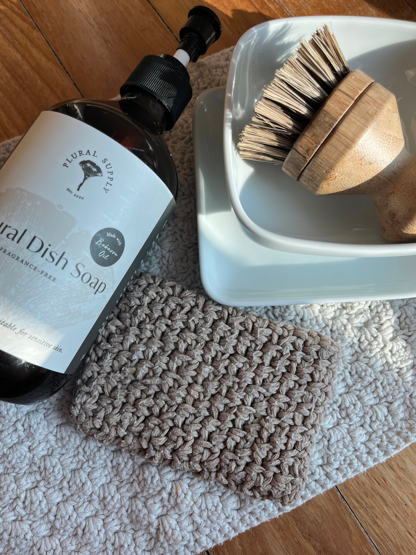 recycled cotton reusable dish sponge with bamboo brush and natural dish soap, on recycled cotton dish cloth. natural, environmentally friendly kitchen tools