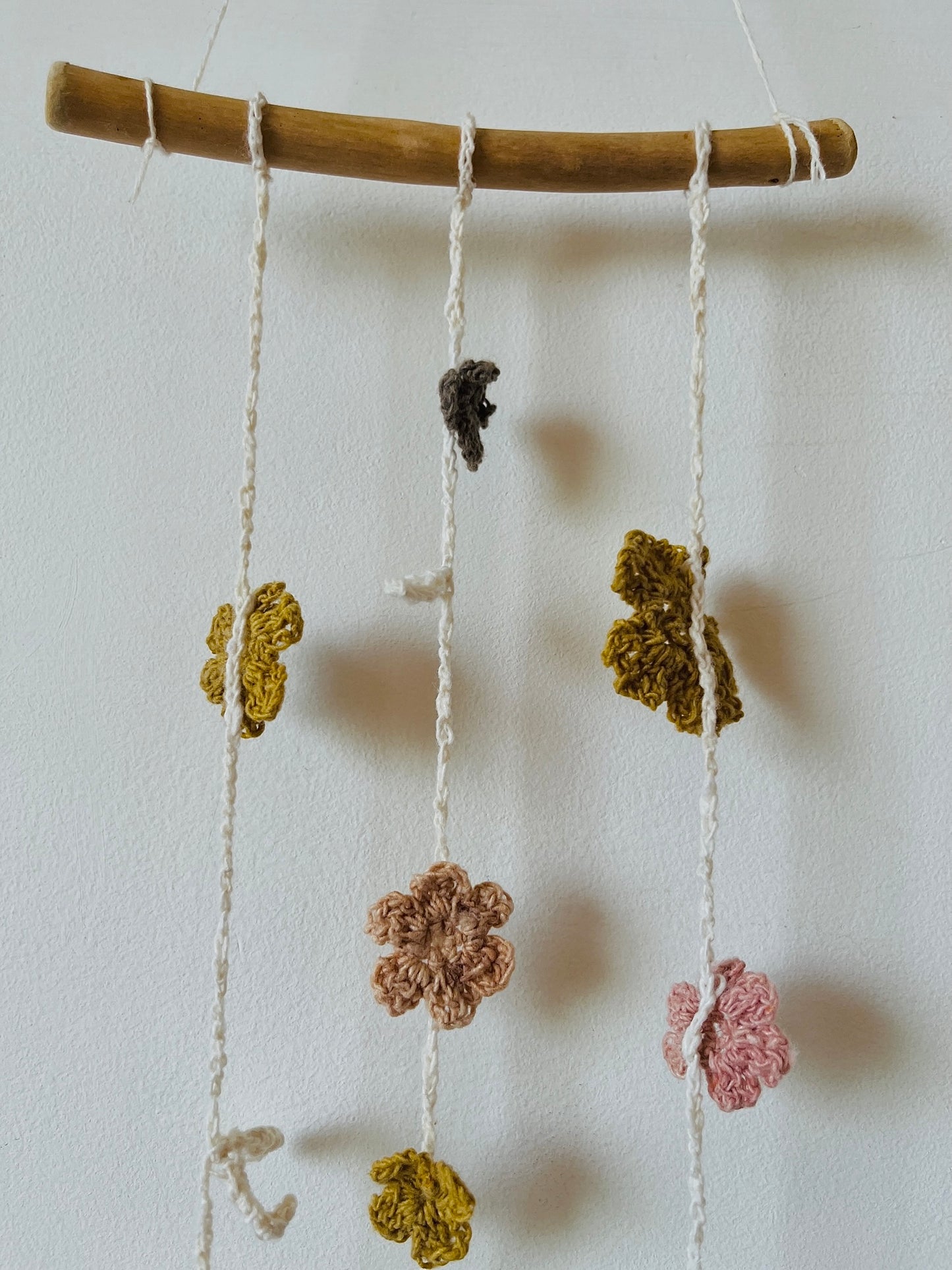 Decorative hanging with crocheted flowers on a white background - zoom in details